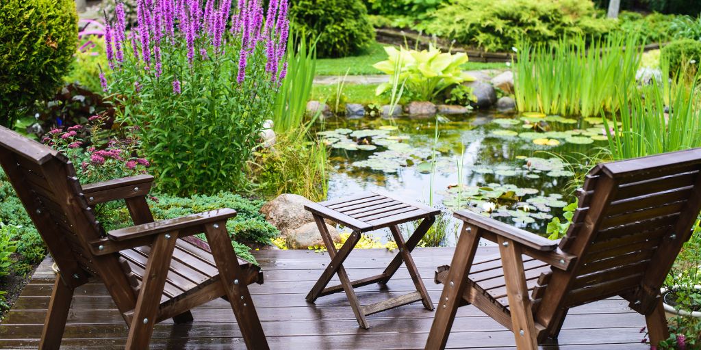 outdoor chairs overlooking pond and flowers